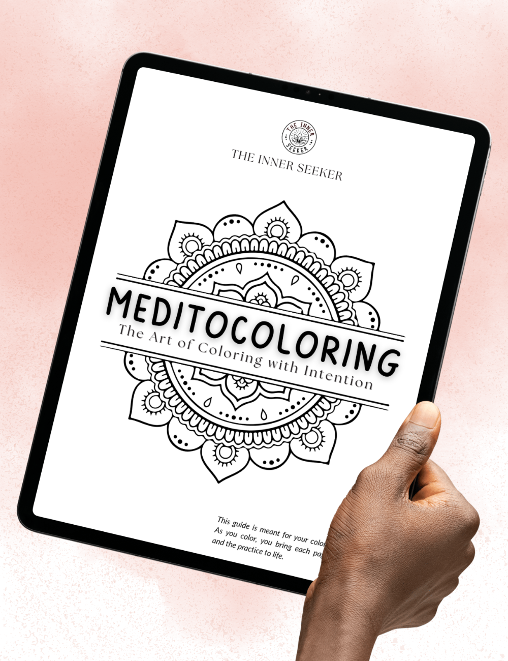 Hand holding a tablet displaying the Meditocoloring Guide cover, The Art of Coloring with Intention.